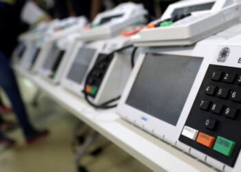 Brazilian electoral workers seal electronic ballot boxes in Manaus