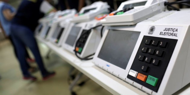 Brazilian electoral workers seal electronic ballot boxes in Manaus