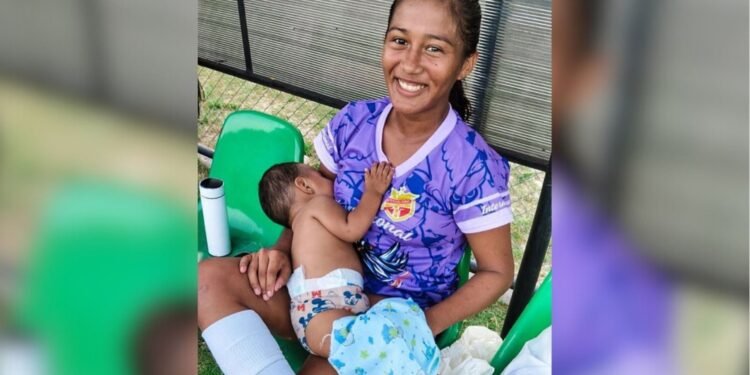 jogadora amamentando o filho